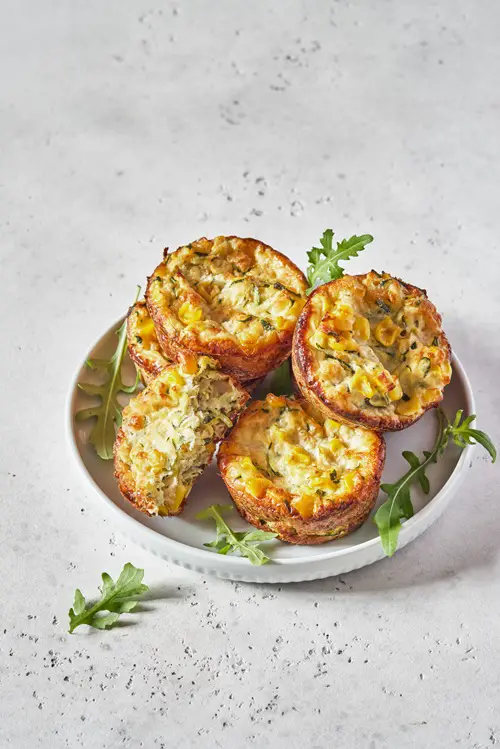 zucchini corn egg muffins on a table for breakfast